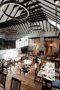 a restaurant with tables and chairs and a fireplace at The Bonnie Badger in Gullane