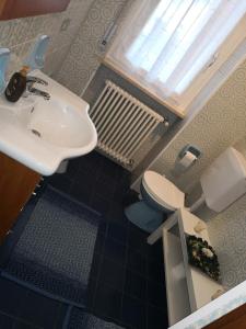 a bathroom with a sink and a toilet and a window at B&B MANITO in Lavena Ponte Tresa +18 photos
