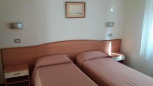 Postel nebo postele na pokoji v ubytování Albergo Moretti
