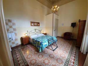 a bedroom with a bed and a rug at Albergo Cavour in Palermo