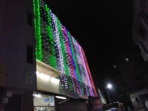 a building with colorful lights on it at night at Shree Yatri Niwas in Kolhapur