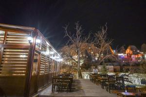 a restaurant with tables and chairs at night at Cappadocia sightseeing Hotel in Goreme