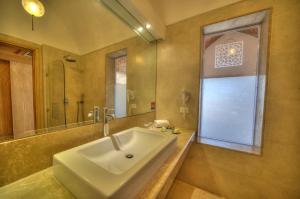 a bathroom with a sink and a large mirror at Shams Alam Beach Resort in Abū Ghuşūn