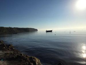 a boat sitting in the water on a lake at Strandhaus Goehren in Göhren +53 photos