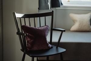 a pillow sitting on a chair in a room at The Bonnie Badger in Gullane