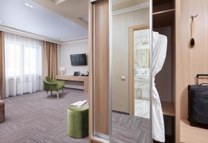 a hotel room with a door leading to a bedroom at Granat Hotel in Nizhny Novgorod
