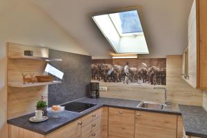 a kitchen with a sink and a skylight at Ferienwohnungen Vogler in Oberstdorf +69 photos