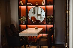 a dining room with a table and a mirror at The Bonnie Badger in Gullane