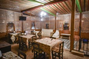 a dining room with tables and chairs and a television at Cappadocia sightseeing Hotel in Göreme