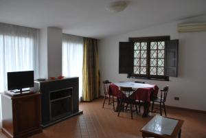 a living room with a table and a dining room at Residence Casale Mostacciano in Rome