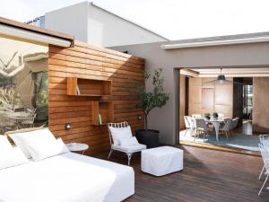 a bedroom with a bed and a patio with a table at New Hotel in Athens