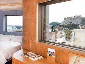 a bedroom with a bed and a window with a view at New Hotel in Athens