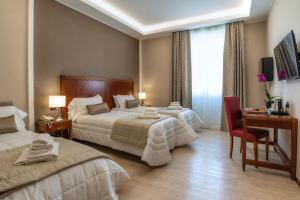 Postel nebo postele na pokoji v ubytování Hotel Genova