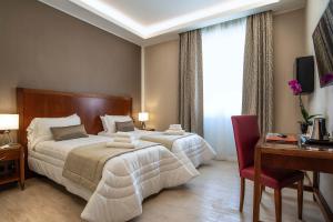 Postel nebo postele na pokoji v ubytování Hotel Genova