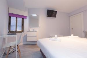 Postel nebo postele na pokoji v ubytování Hostal Viena