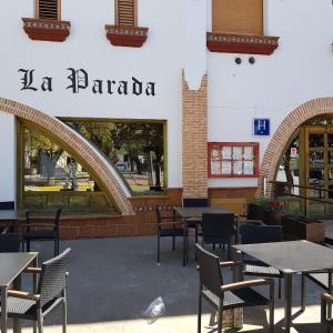 a restaurant with tables and chairs in front of a building at Hostal La Parada in Pedro Muñoz +16 photos