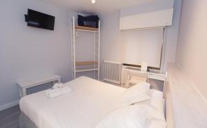 Postel nebo postele na pokoji v ubytování Hostal Viena