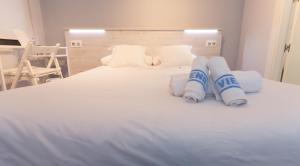 Postel nebo postele na pokoji v ubytování Hostal Viena