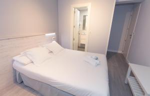 Postel nebo postele na pokoji v ubytování Hostal Viena