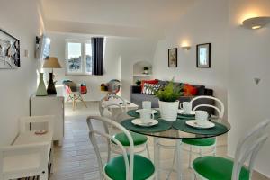 a kitchen and living room with a table and chairs at Apartamentos Tucha in Albufeira