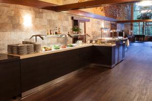 
a large kitchen with a large counter top at Hotel Patria in Štrbské Pleso
