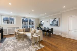 a living room with a couch and a table at ALTIDO Luxury 2 bed flats with terraces near Piccadilly Circus in London