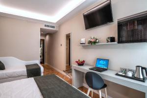 Cette chambre comprend un lit et un bureau avec un ordinateur portable. dans l'établissement Hotel Memphis, à Rome