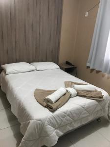 Postel nebo postele na pokoji v ubytování Conquista Palace Hotel