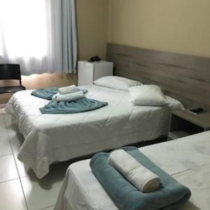 Postel nebo postele na pokoji v ubytování Conquista Palace Hotel