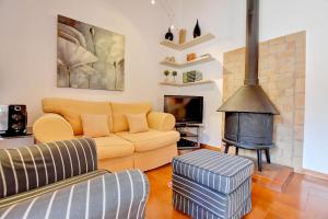 a living room with a couch and a fireplace at Villa Bell Lloc by SOMNIA in Felanitx