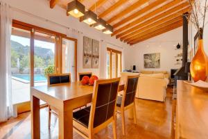a dining room and living room with a table and chairs at Villa Bell Lloc by SOMNIA in Felanitx +99 photos