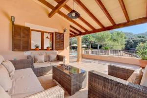 a patio with a couch and chairs and a table at Villa Bell Lloc by SOMNIA in Felanitx