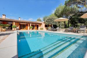 a swimming pool in front of a house at Villa Bell Lloc by SOMNIA in Felanitx