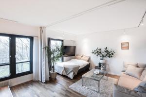 a living room with a bed and a couch at HOMELY - Executive Suite 72m2 -Sauna in Helsinki