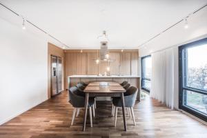 a kitchen and dining room with a table and chairs at HOMELY - Executive Suite 72m2 -Sauna in Helsinki
