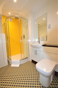 a bathroom with a shower and a toilet and a sink at Brunel Loft Apartments - YA in Bristol