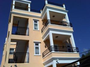 a tall building with balconies on the side of it at Trou Aux Biches Self Catering Apartment in Trou aux Biches
