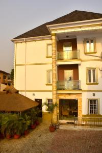 a large yellow building with a fireplace in front of it at Mountain Top Lodge Hotel in Lagos