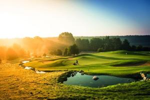 a view of a golf course with a pond at Gut Vorbeck in Gneven