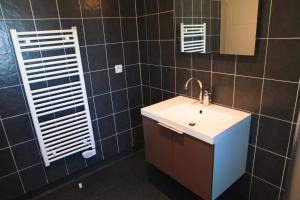 a bathroom with a sink and a mirror at Les Terrasses de l'Océan in Saint-Hilaire-de-Riez +37 photos