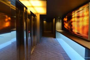 a hallway of a building with a tv on the wall at Hotel Soho in Barcelona