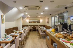 a dining room with long tables and chairs at Bizim Hotel in Istanbul