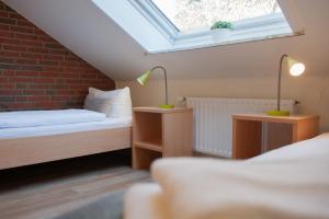 a attic bedroom with two beds and a skylight at campushus in Sankt Peter-Ording