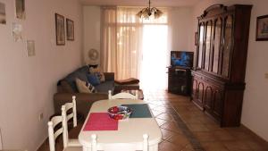 a living room with a table and a couch at Holiday apartment Paraiso in Playa Paraiso