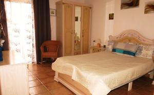 a bedroom with a bed and a chair in it at Holiday apartment Paraiso in Playa Paraiso +17 photos
