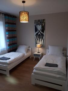 Postel nebo postele na pokoji v ubytování Apartamenty pod Dzikowcem