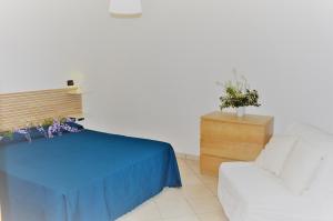 En eller flere senge i et værelse på Baia Etrusca Resort