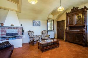 a living room with a couch and a piano at Cascina Tetto del Priore in Cuneo