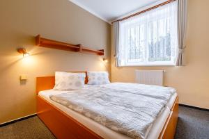 Postel nebo postele na pokoji v ubytování Hotel Jitřenka