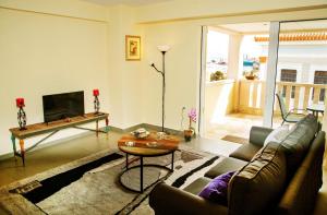 a living room with a couch and a table at Catherine's Comfort Apartment No2 in Lavrio